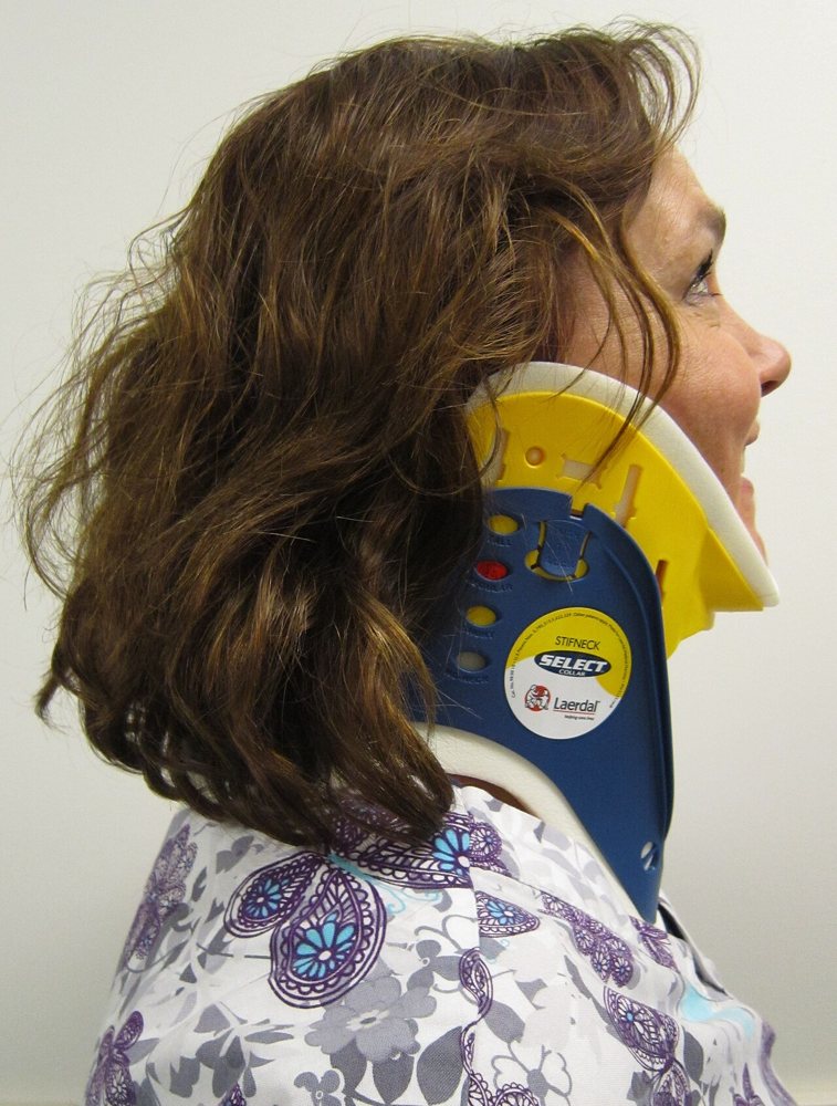 Adjustable extrication cervical collar fitted on an adult, side view
