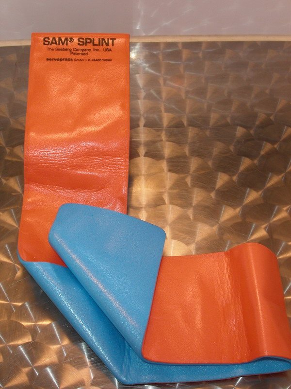SAM splint: flexible padded splint, orange and blue, partly unrolled